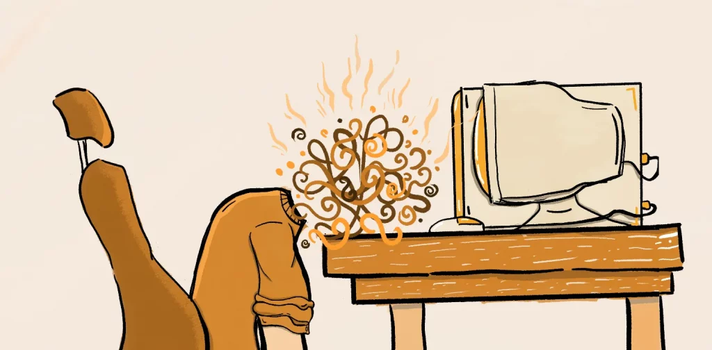 seorang pria yang berada di depan komputer sedang menundukan kepalanya yang penuh dengan fikiran akibat burnout mental health