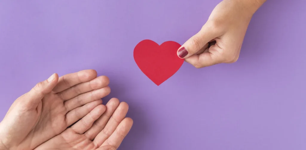 hand giving heart to other hands