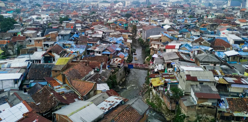 foto udara pemukiman padat yang ada di dekat bantaran sungai perkotaan