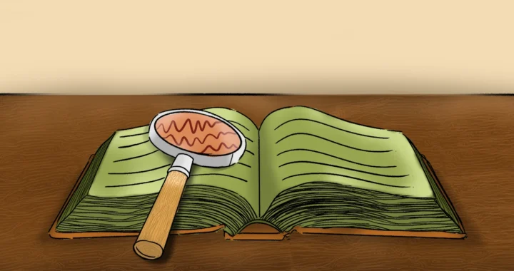 buku terbuka dengan kaca pembesar tergeletak di atasnya