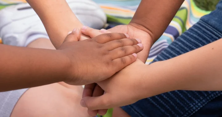 Empat tangan anak-anak yang saling berpegangan