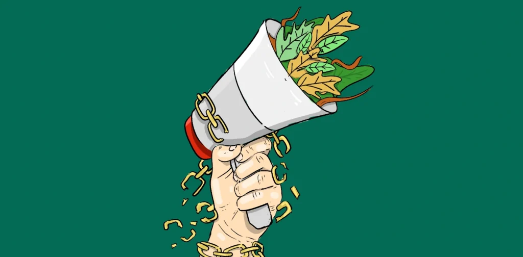 tangan terangkat memegang megafon dengan rantai yang terputus