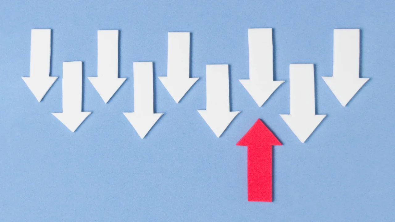 satu parah merah ke atas berhadapan dengan sembilan panah putih ke arah bawah